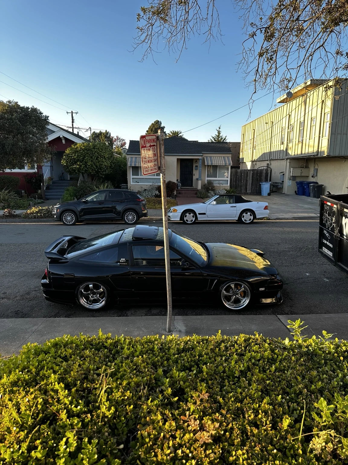Black enthusiast coupe parked on a Berkeley street