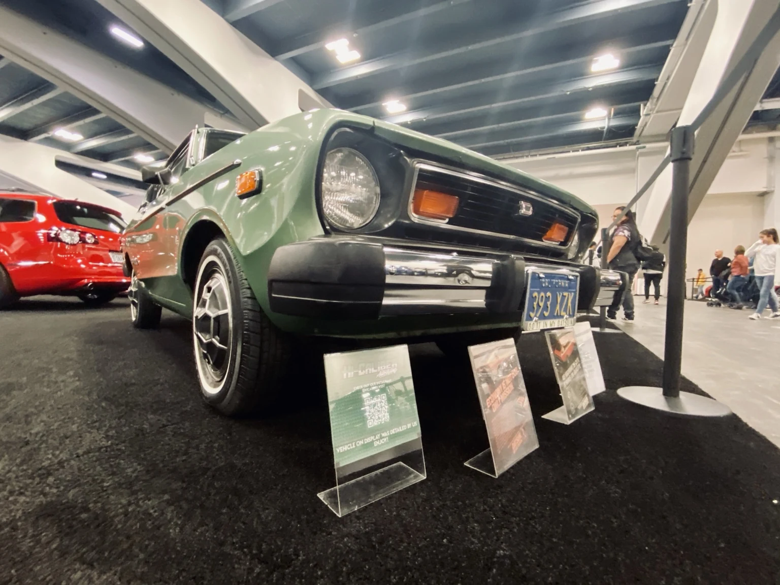 Classic green coupe displayed indoors